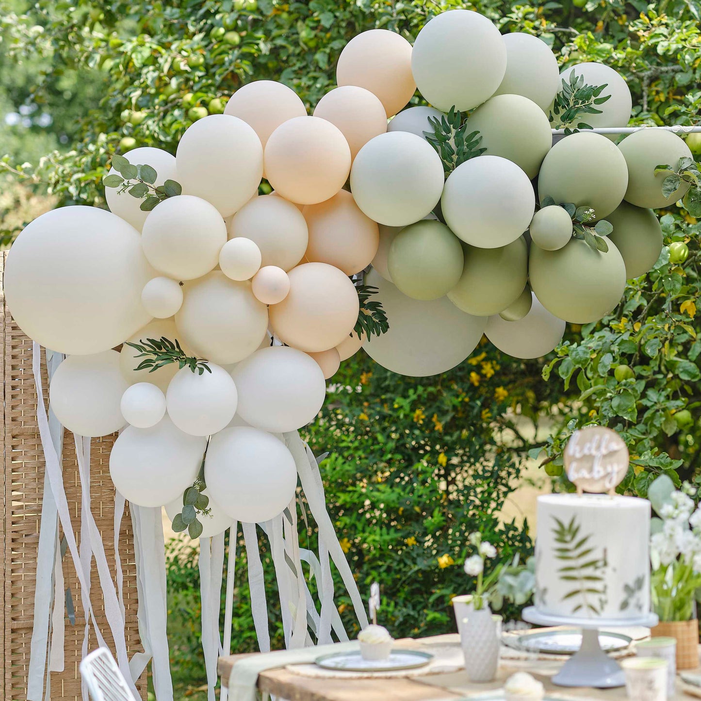 Botanical balloon arch with eucalyptus and sage leaves and streamers